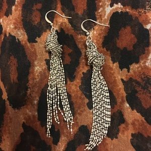 Silver-tone dangle earring.